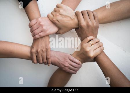 Professional young business people handsake, united, joining , combine hands together expressing positive, unity, volunteer , teamwork concepts. Stock Photo