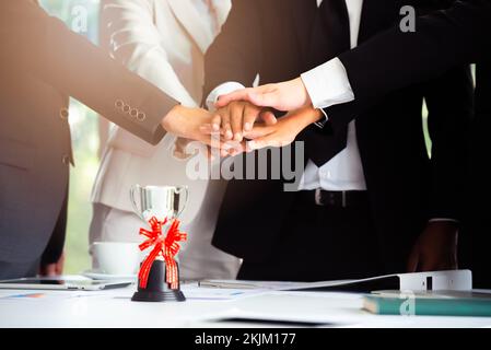 Teamwork business people put hands together to succeed in the business. Stock Photo