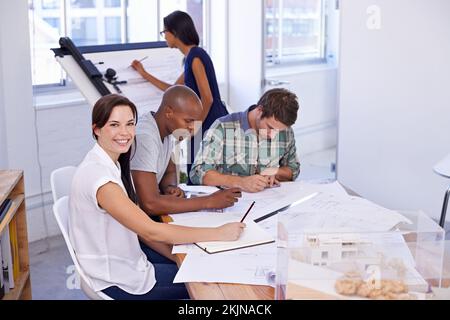 These new designs are going to wow the clients. a architectural colleagues working in the office. Stock Photo