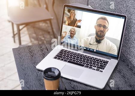 Man Working From Home Having Online Group Videoconference On Laptop Stock Photo