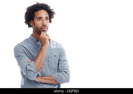 Every thought we think is creating our future. Studio shot of a handsome man looking thoughtful isolated on white. Stock Photo