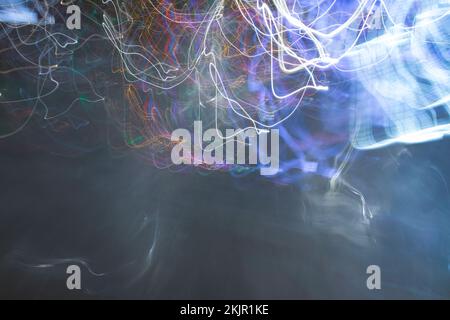 City night lights perspective blurred, drugs like perceptions. Vivid, tangled streaks of light. Stock Photo