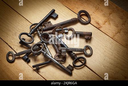 Branch old keys on a background of wooden boards Stock Photo