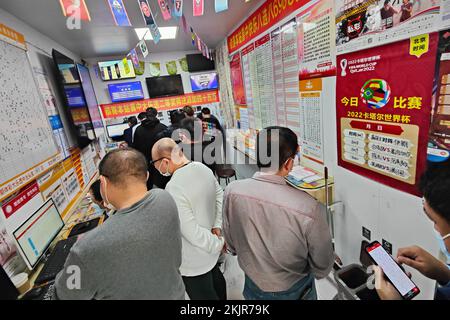 SHANGHAI, CHINA - NOVEMBER 25, 2022 - People line up to buy World Cup soccer lottery at a Chinese sports lottery site in Shanghai, China, November 25, Stock Photo
