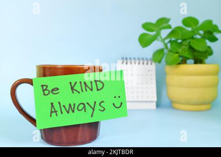 Be kind always motivation and inspiration kindness concept. Selective focus of a cup of coffee with handwritten bright paper note. Stock Photo