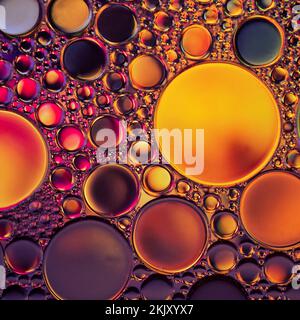 multicolored oil circles on the water, abstract background Stock Photo