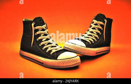 A 3D illustration of sneakers on an orange background Stock Photo