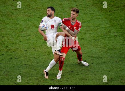 Iran's Karim Ansarifard battles with Wales’ Joe Rodon during the FIFA World Cup Group B match at the Ahmad Bin Ali Stadium, Al-Rayyan. Picture date: Friday November 25, 2022. Stock Photo