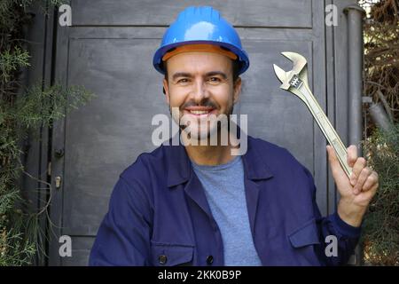 Maintenance worker holding large adjustable wrench Stock Photo