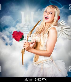 Heavenly angel of love laughing with halo on head in front of the gates of heaven. Love is the key. Stock Photo