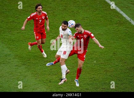Iran's Karim Ansarifard battles with Wales’ Ben Davies during the FIFA World Cup Group B match at the Ahmad Bin Ali Stadium, Al-Rayyan. Picture date: Friday November 25, 2022. Stock Photo