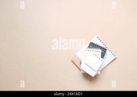 deadline concept with stack of calendar and pencil on color background  Stock Photo