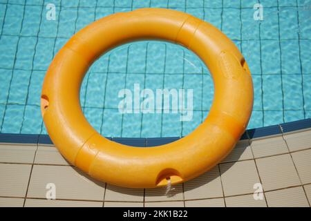 Red life buoy in swimming pool.. Help and support concept. Stock Photo