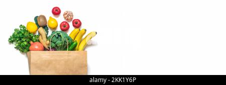 Eco friendly paper shop bag with raw organic green vegetables isolated on white background Flat lay, top view Zero waste, plastic free concept Healthy Stock Photo