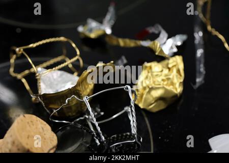 Helsinki, Finland, Jan 2021: Trash after popping some champagne, other bubbly drinks and wine bottles - caps, metal, aluminium... Day after New Year. Stock Photo