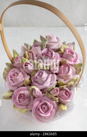 Pastel trend colored flowers in white basket isolated, floristic wedding present background, March 8, Womens Stock Photo