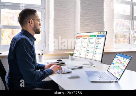 Digital Calendar Schedule Software In Office. Scrum Mobile Phone App Stock Photo