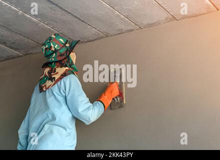 Plasterer create new walls and ceiling at construction site. Interior building.. Stock Photo