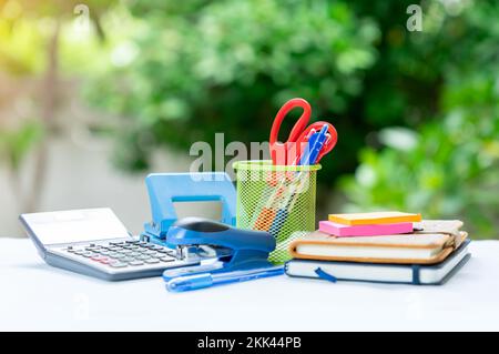 Stationary and notebook paste on wooden table and out of focus background. Stock Photo