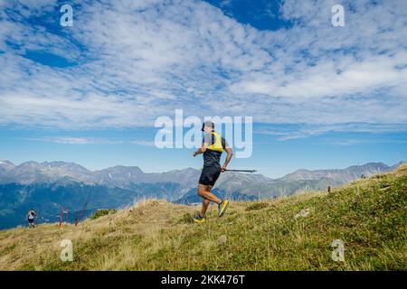 male runner running mountain trail race Stock Photo