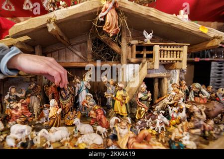 Nuremberg, Germany. 25th Nov, 2022. A hand-carved wooden nativity scene is on display for sale at the Nuremberg Christkindlesmarkt. The Nuremberg Christ Child officially opens this year's Christkindlesmarkt in the late afternoon with the ceremonial prologue. Credit: Daniel Karmann/dpa/Alamy Live News Stock Photo