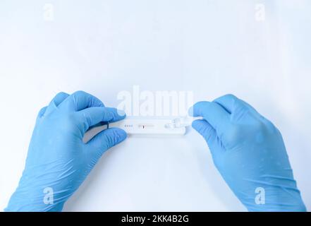 Using a covid 19 rapid test - test liquid is filled into the test cassette isolate on white background Stock Photo