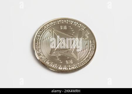 Silver physical Ethereum coin on white background. Digital currency, cryptocurrency, blockchain technology concept. Stock Photo