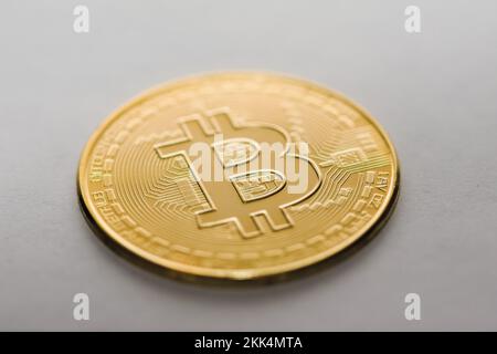 Golden physical Bitcoin on white background. Digital currency, cryptocurrency, blockchain technology concept. Stock Photo