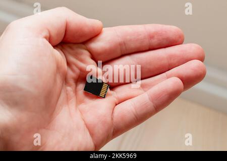 Holding micro SDHC card in a hand - shallow focus Stock Photo