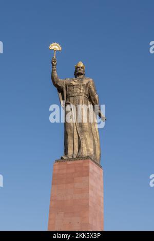 Khujand, Sughd, Tajikistan - 08 18 2022 : Low angle view of statue of national hero Ismoil Somoni in public park on blue sky background Stock Photo