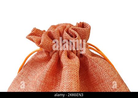 Front view of orange red fabric drawstring gift bag isolated on white background with clipping path. Stock Photo