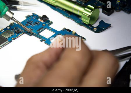 smartphone repair smartphone Soldered parts, male, close-up Stock Photo