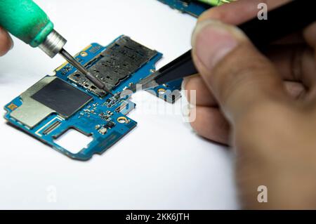 smartphone repair smartphone Soldered parts, male, close-up Stock Photo