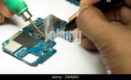 smartphone repair smartphone Soldered parts, male, close-up Stock Photo
