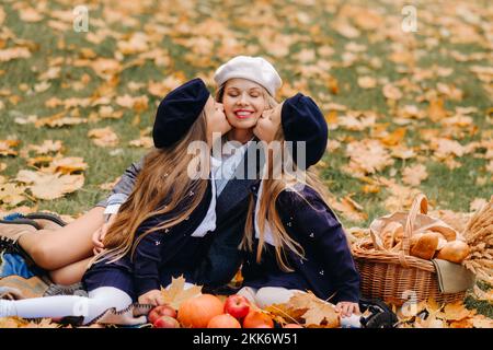 A big family on a picnic in the fall in a nature park. Happy people in the autumn park Stock Photo