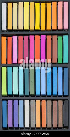 A box of pastel chalks - many different, intense colours in a pastel chalk box, ready to create a work of art - beautiful colours to create a work of Stock Photo