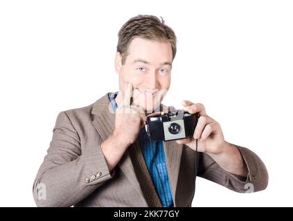 Isolated image of a funny man gesturing big smile while taking happy snap with vintage camera Stock Photo