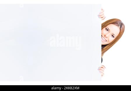 Studio Portrait Of A Cute And Funny Business Woman Peering And Peeking Behind A Big Blank Sign In A Advert Commercial And Communication Message Concep Stock Photo