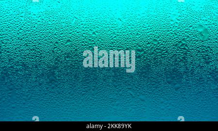 Texture of Water Droplets on Chilled Drink Glass in Gradient Turquoise Blue Color Stock Photo