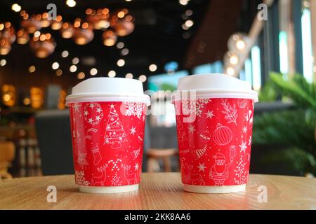Closeup of Two Red and White Takeaway Coffee Cup on the Table Stock Photo