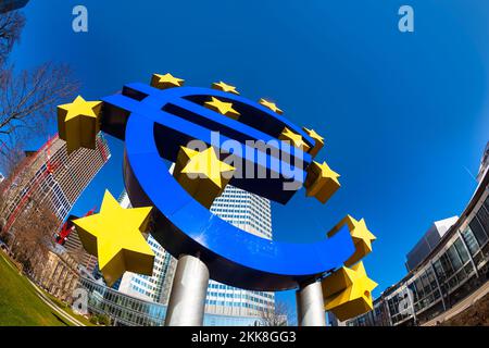 Frankfurt, Germany - March 2, 2013: Euro sign in Frankfurt with skyline and blue sky. Stock Photo