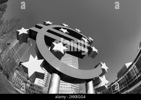 Frankfurt, Germany - March 2, 2013: Euro sign in Frankfurt with skyline and blue sky. Stock Photo