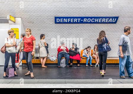 Paris, France - June 12, 2015:  people wait in the Metro station for next arriving train.