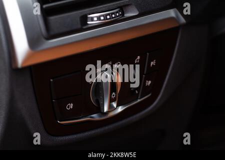 Closeup of the headlight switch control button. Lights control panel in car Stock Photo