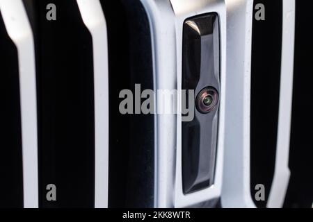Close up view of front parking assist video camera on the car. Front view camera of modern car. Stock Photo