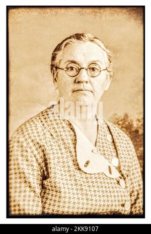 Photographer's grandmother who died in mid to late 1950s.    Vintage sepia tone 1930’s formal portrait of a middle aged lady. Stock Photo