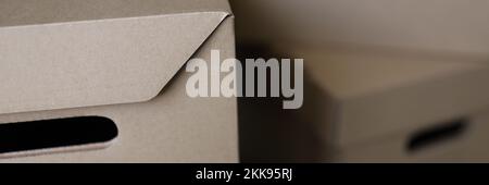 Empty solid cardboard boxes with covers, beige containers to storage things Stock Photo