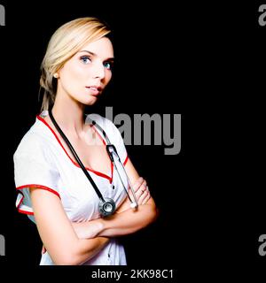 Gorgeous young blonde nurse who takes her work serious with stethescope Stock Photo
