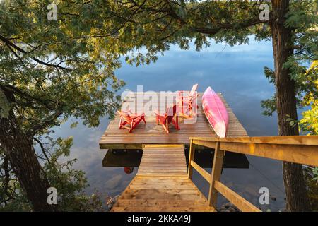 An inviting view of a dock on a calm lake Stock Photo