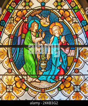 BIELLA, ITALY - JULY 15, 2022: The Annunciation in the stained glass of Duomo from 19. cent. Stock Photo